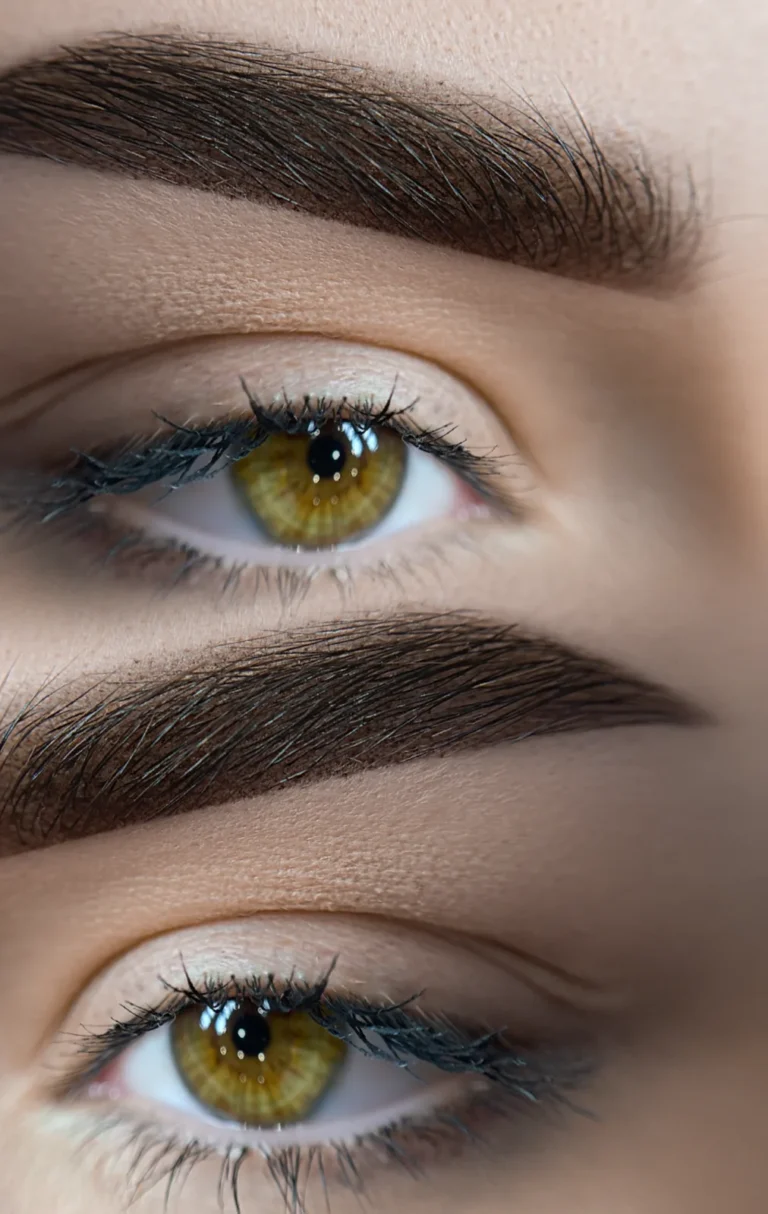 Close-up of softly shaded, defined brows above hazel eyes